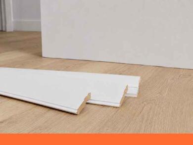 Pièce lumineuse avec des plinthes blanches installées le long des murs, montrant un résultat propre et harmonieux après les travaux de finition.